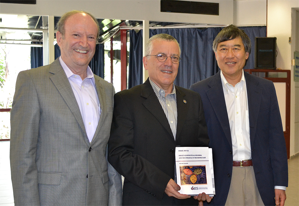 Professor Yoram Peri, Professor Boaz Golany and Wallace D. Loh pictured holding a book