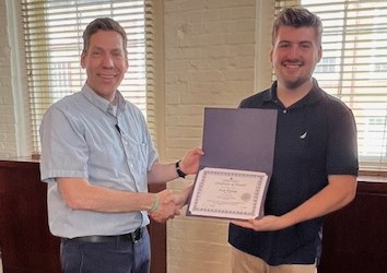 Ilai Saltzman presenting Cody Flerlage with ISRL Minor Scholarship certificate