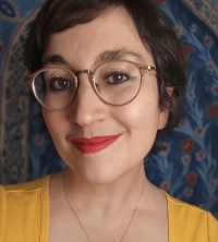 Head pic of Anna Elena Torres with a floral printed background